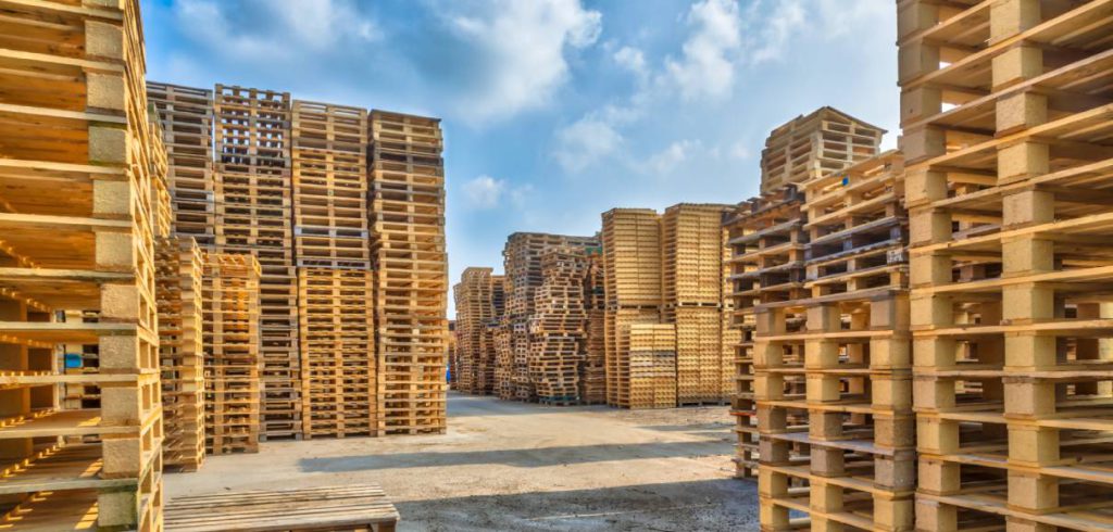 Stacks and rows of wooden pallets in storage following pallet storage best practices.