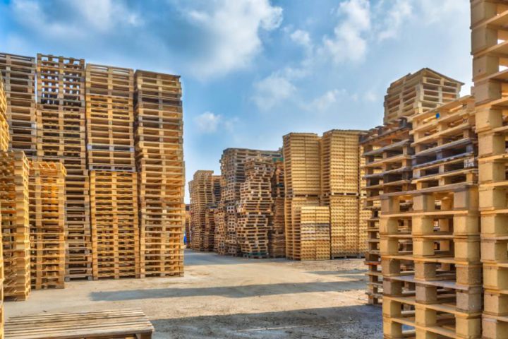 Stacks and rows of wooden pallets in storage following pallet storage best practices.