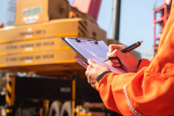 A manager checking and monitoring equipment and workers closely to ensure the site stays productive and safe.