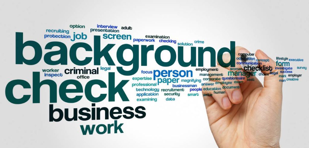 A hand holding a marker. In front of the hand is a word cloud. Various words about work surround the word background check.