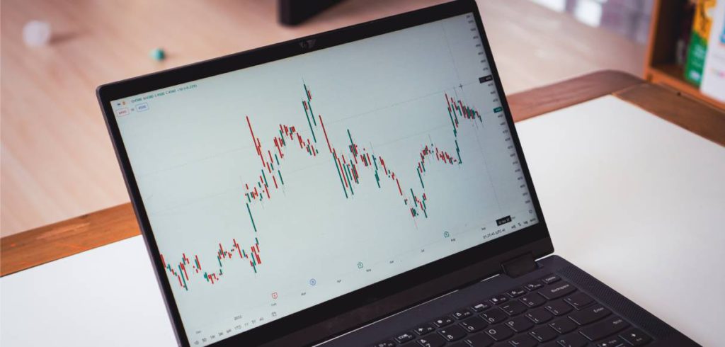 A laptop screen shows a company’s stock price, which is currently unpredictable and indicative of the larger economy.